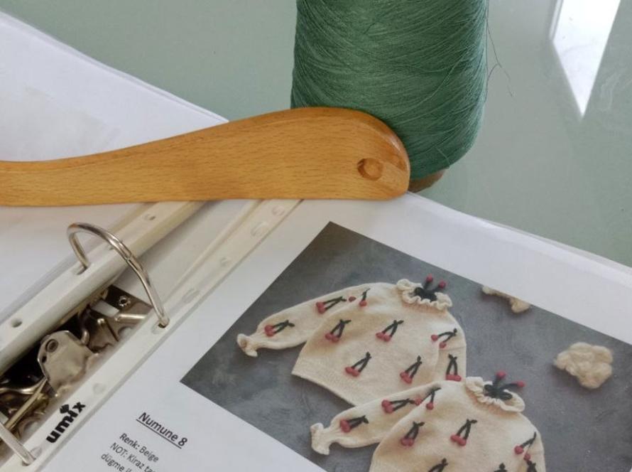 Artisan crafting custom knitwear design in workshop. UBBA Textile